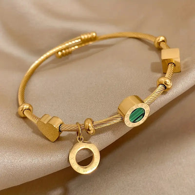 Pulseira rígida dourada com pingentes geométricos - Celeste