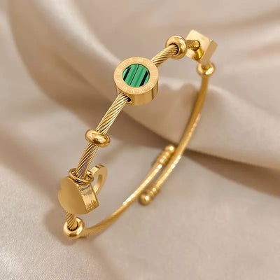 Pulseira rígida dourada com pingentes geométricos - Celeste